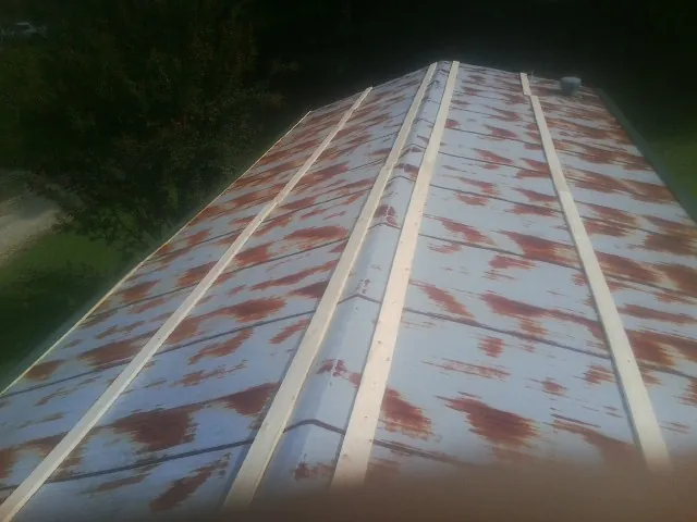 Rusted metal roof panels with new wood purlins before replacement — Storm Damage Roof Repair in Wauconda by Roofing Brothers